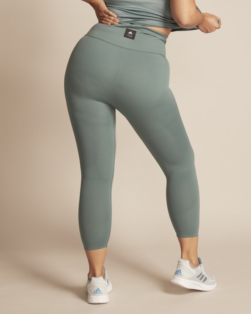Back of a model wearing a size 1X 11 Honoré x Adidas Formotion Legging in Light Blue by Adidas x 11 Honoré. | dia_product_style_image_id:248499